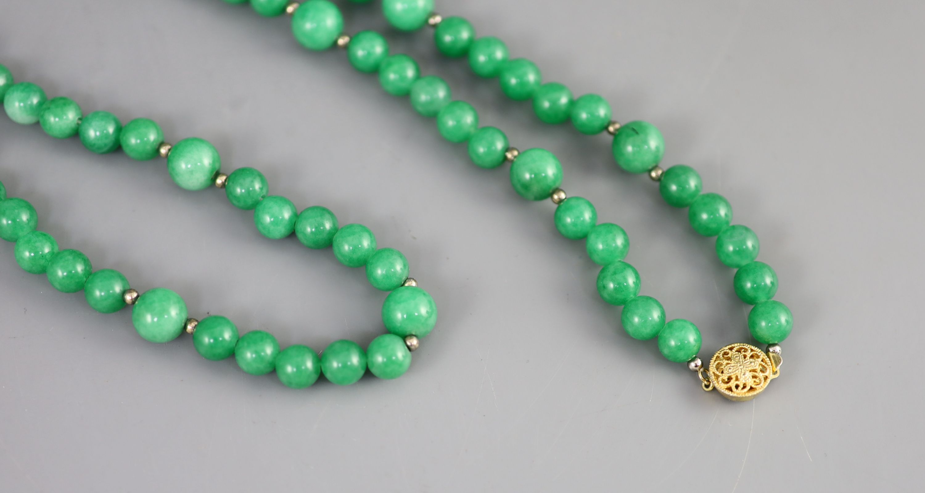 A Chinese green jadeite bead necklace, 51cm drop